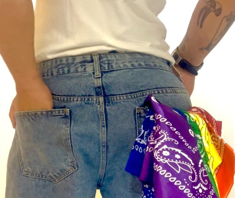 Bandanas coloridas presas ao bolso traseiro de uma calça jeans, referência ao código hanky.